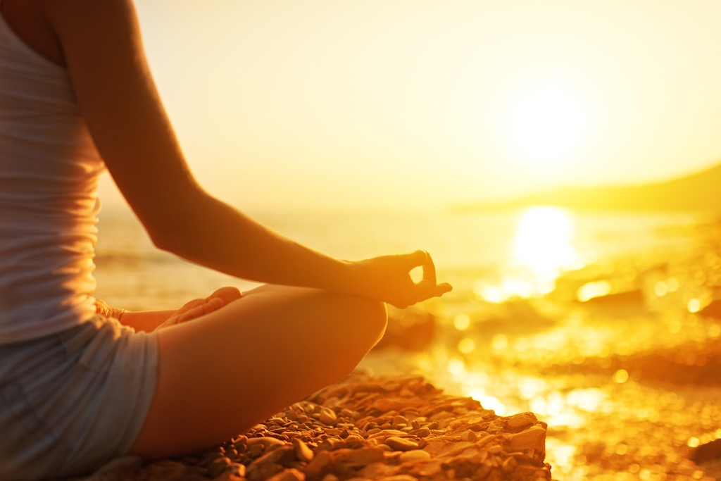 Hand ff Woman Meditating in a Yoga Pose on Beach