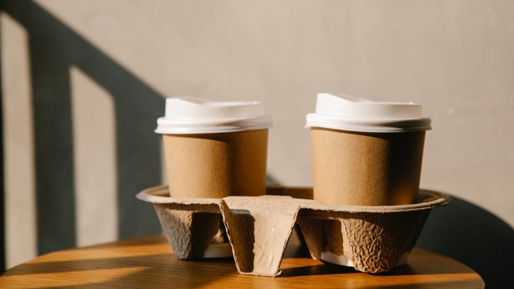 Cardboard cups on holder tray on table